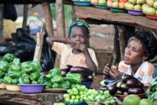 A mother and child sell vegetables at a roadside stand in Kampala, Uganda. © 2011 Rachel Steckelberg, Courtesy of Photoshare